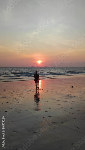 Silhouette Traveller walking on the beach and take a picture Sunset of Had Yao Beach Kantang is beautiful long beach with limestone - unseen thailand beach in Trang Thailand - Travel Footage cLip photo