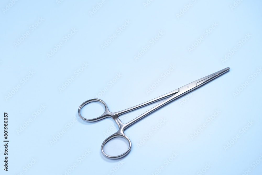 A pair of scissors with a silver handle and a silver blade. The scissors are pointed and ready to be used A pair of scissors with a silver handle and a silver blade. The scissors are pointed and ready to be used
