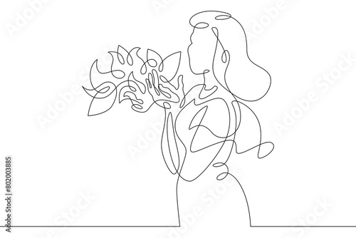 One continuous line. Spring. A young girl with a flowering tree.Spring flowers. Romantic girl with flowers. Continuous line drawing.Line Art isolated white background.