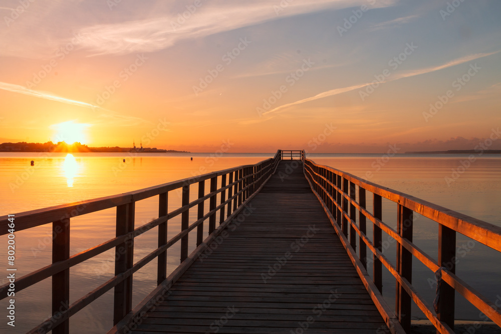 Romantischer Steg an der Ostsee im Sommer bei Sonnenaufgang.