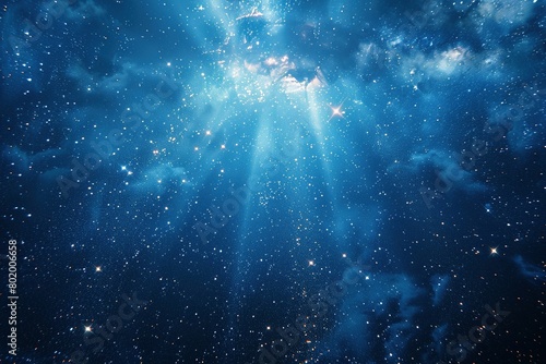 A mesmerizing deep blue canvas explodes with a radiant burst of starlight, casting rays in all directions. photo
