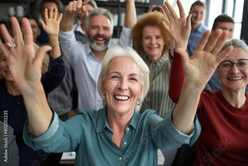 Portrait of happy senior businesswoman raising hands in office. Cheerful senior businesswoman gesturing with hands. © Iigo
