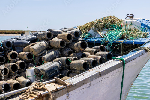 Santa Luzia, Portugal 04-16-2024. Boat withe Container used to catch octopuses in the fishing port of Santa Luzia in Portugal.