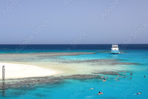 Enchanting view of Egypt's Red Sea coral reef near Marsa Alam, Hamata Islands. Crystal-clear turquoise waters under a warm, sunny sky, perfect for snorkeling.