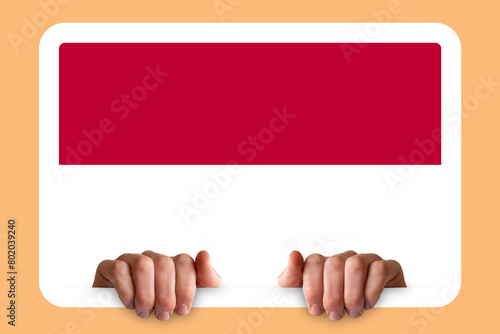 Hands holding a white frame with Indonesia flag, celebration or campaigning concept, two hands 