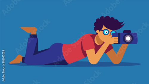 A photographer laying on the ground camera in hand capturing the perfect shot with intense focus.. Vector illustration