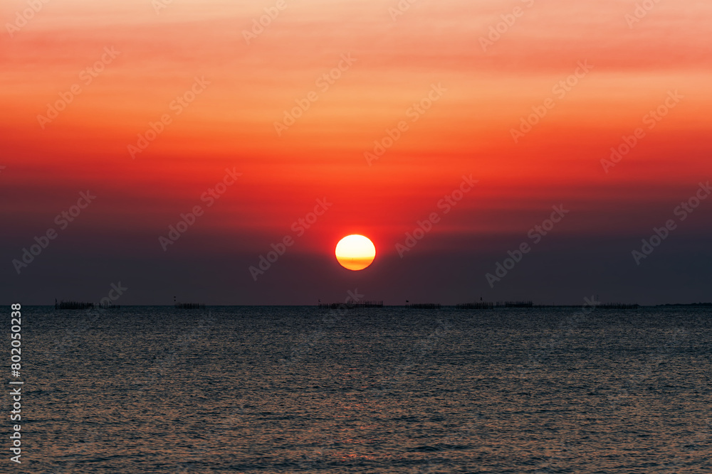 Sunset over the sea background. Big sun over the sea with beautiful natural light at sunset or sunrise. Sunset over the sea background. Big sun over the sea with beautiful natural light at sunset or sunrise.