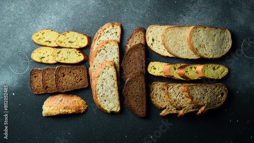 Slices of different types of bread. Assortment of rye, bran and sourdough bread. Top view. © Yaruniv-Studio