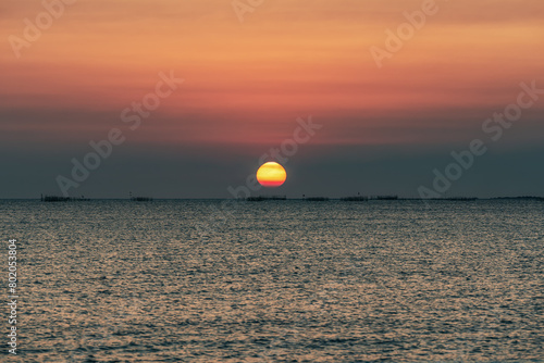 Fototapeta Naklejka Na Ścianę i Meble -  Sunset over the sea background. Big sun over the sea with beautiful natural light at sunset or sunrise.