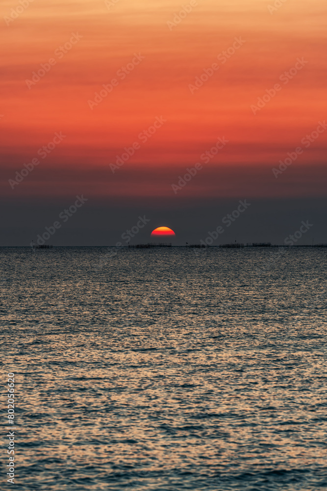 Sunset over the sea background. Big sun over the sea with beautiful natural light at sunset or sunrise. Sunset over the sea background. Big sun over the sea with beautiful natural light at sunset or sunrise.