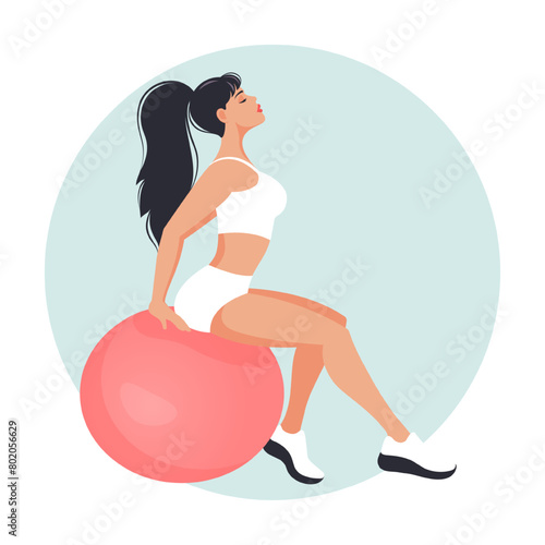 Beautiful girl sitting on a big fitness ball
