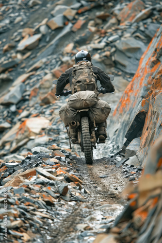 A man is riding a dirt bike on a rocky road. Concept of adventure and excitement  as the man navigates the challenging terrain