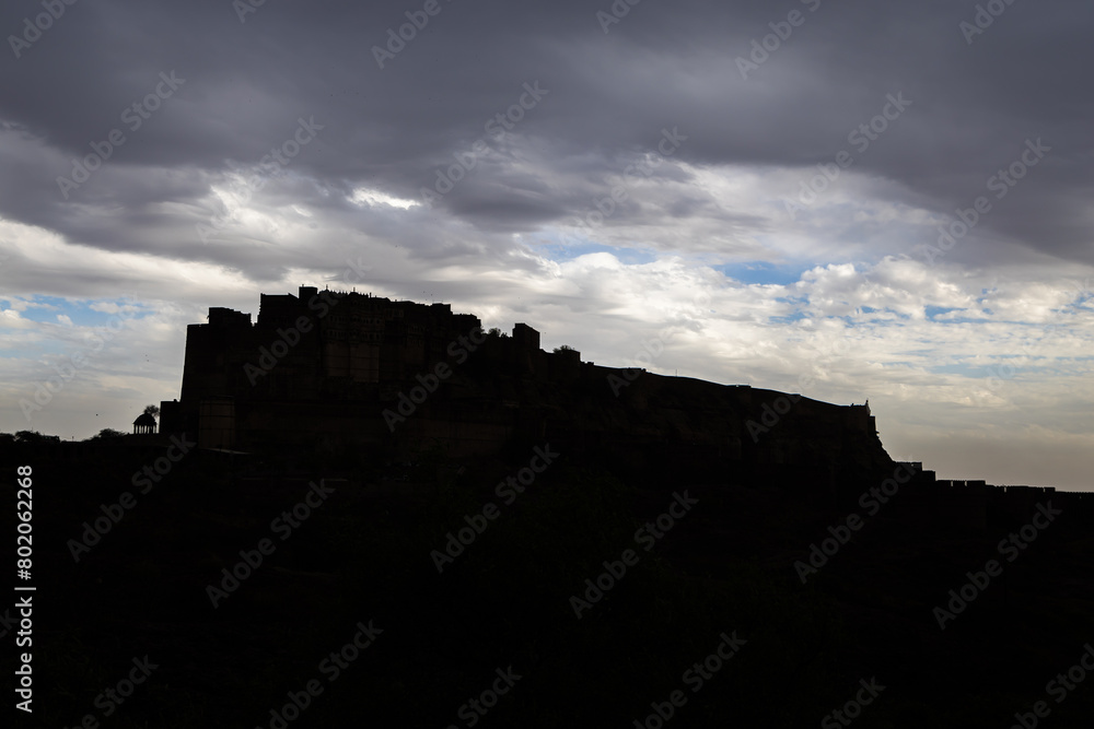 backlit shot of ancient historical fort with dramatic cloudy sky at evening from different angle backlit shot of ancient historical fort with dramatic cloudy sky at evening from different angle