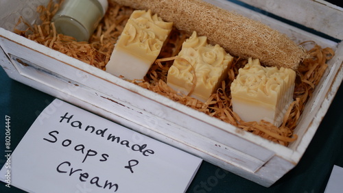 Handmade soaps and cream in a wooden box.