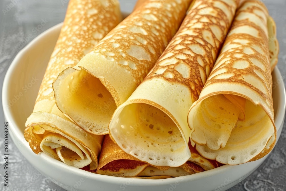 Top view of rolled pancakes on light background with ample space for text placement