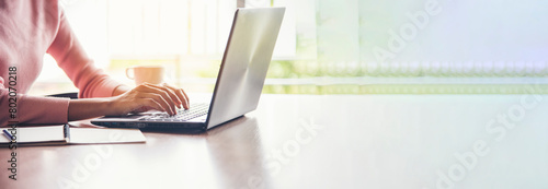 Banner Businesswoman reading financial graph charts business info with computer laptop. Panorama Women hands using laptop on office desk. Hands of business woman working office with copy space © aFotostock