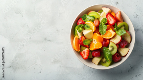 Bowl with fruit salad on light background --ar 169