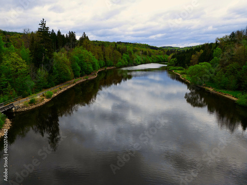 Secluded Nature: Serene Lakeside Road with Cliff and Forest