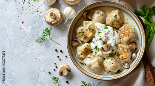 Bowl with tasty dumplings sour cream and mushrooms 