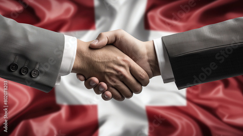 Business Handschlag mit Hintergrund Flagge schweiz - Business handshake with background flag of Switzerland