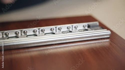 Wallpaper Mural A man assembles furniture, screws a ball guide onto a piece of furniture. Close-up. Assembling furniture at home. Torontodigital.ca