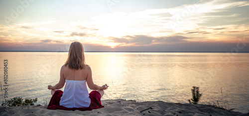 Woman meditating at the sea