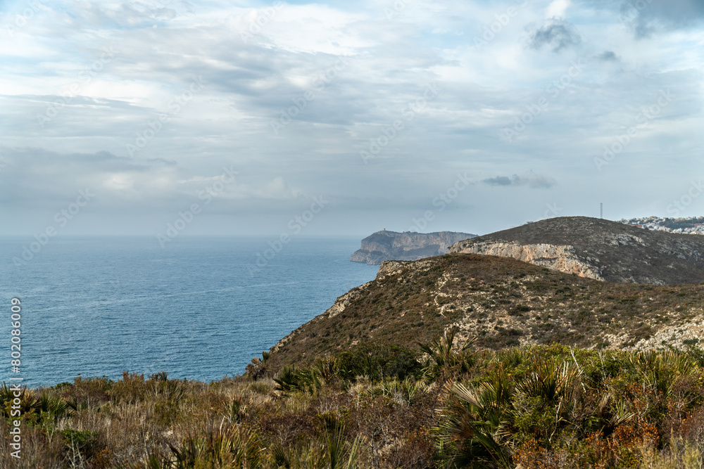 Panoramic view, cliffs and Mediterranean sea on a cloudy morning day, in Jávea, Alicante (Spain). Panoramic view, cliffs and Mediterranean sea on a cloudy morning day, in Jávea, Alicante (Spain).