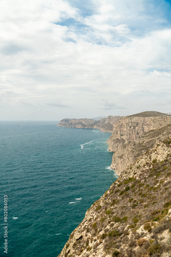 Panoramic view, cliffs and Mediterranean sea on a cloudy morning day, in Jávea, Alicante (Spain). Panoramic view, cliffs and Mediterranean sea on a cloudy morning day, in Jávea, Alicante (Spain).