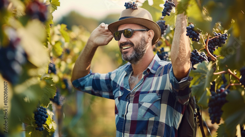 Smiling Farmer Proudly Overseeing Grapevines .