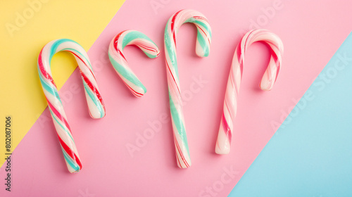 Candy canes on color background