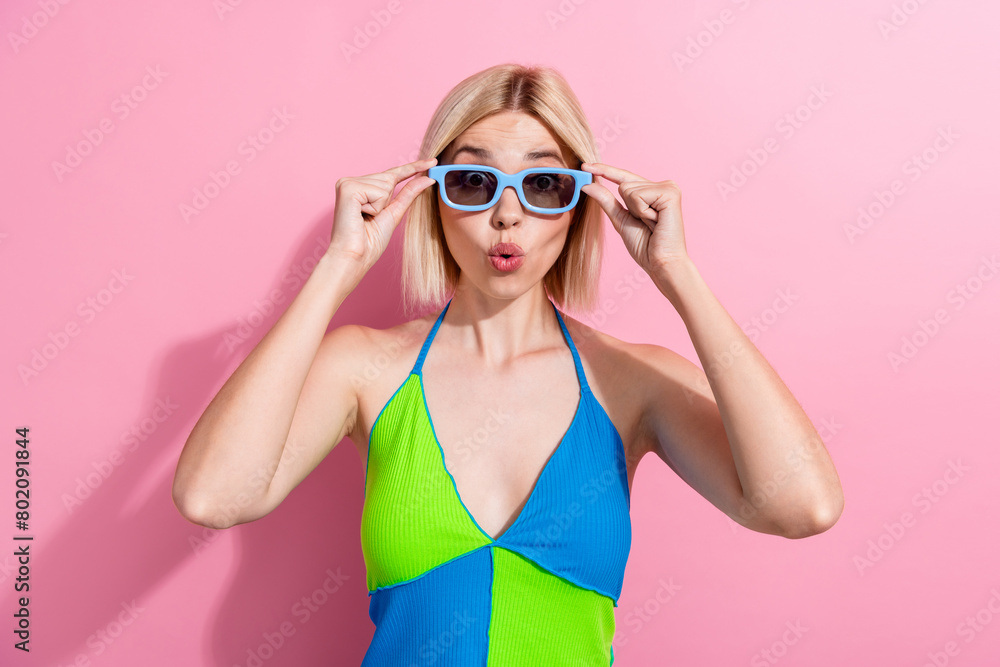 Photo of astonished girl with bob hairdo dressed colorful tank staring at illusion in 3d glasses isolated on pink color background Photo of astonished girl with bob hairdo dressed colorful tank staring at illusion in 3d glasses isolated on pink color background