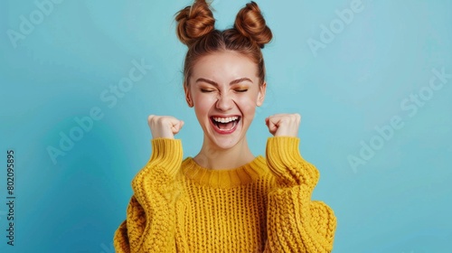 Portrait of delighted lady luck lucky triumph raise fists close eyes content rejoice scream shout yeah mover move in settlement loan beautiful bun trendy stylish sweater isolated on blue background  photo