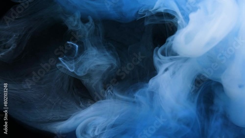 white smoke swirls gracefully in a dark, serene space, creating a mesmerizing spectacle. (ID: 802103248)