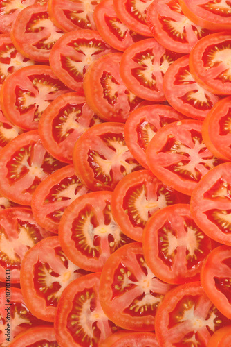 Fotografie Sliced tomato background. Top view.