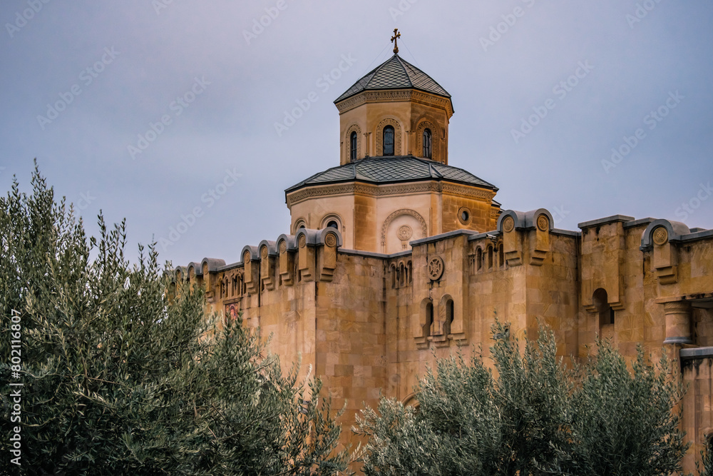 The grounds of Sameba cathedral, surrounded by olive trees and ramparts in Tbilisi, Georgia The grounds of Sameba cathedral, surrounded by olive trees and ramparts in Tbilisi, Georgia