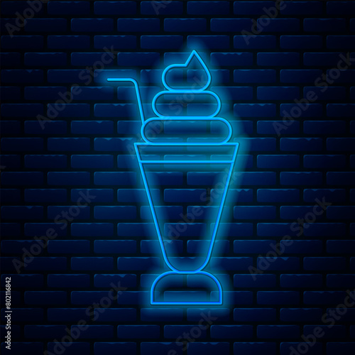 Glowing neon line Milkshake icon isolated on brick wall background. Plastic cup with lid and straw. Vector