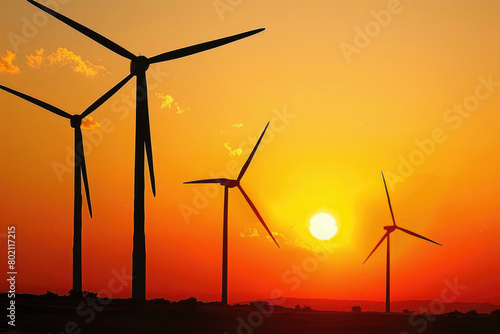 Wind turbines against a setting sun