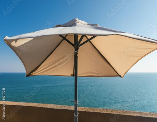 Minimal summer holidays vacation concept. Beach umbrella in front of blue sky and sea. Chilling  lounging on the beach