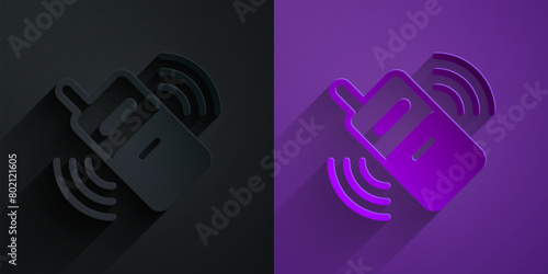 Paper cut Smartphone, mobile phone icon isolated on black on purple background. Paper art style. Vector