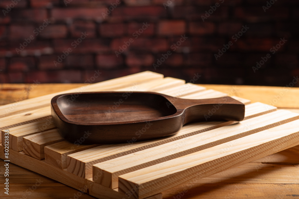 Wooden tray, details of an empty wooden tray on rustic wooden surface, selective focus. Wooden tray, details of an empty wooden tray on rustic wooden surface, selective focus.