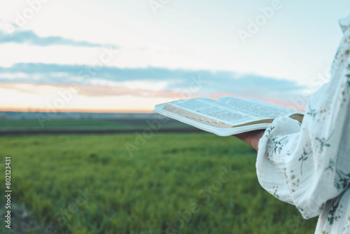 Open bible in hands close-up, concept of calmness and morning solitude