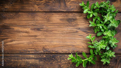 A wooden background with green leaves on it
