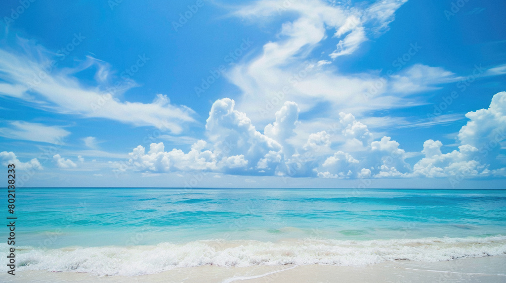 A beautiful blue ocean with a few clouds in the sky