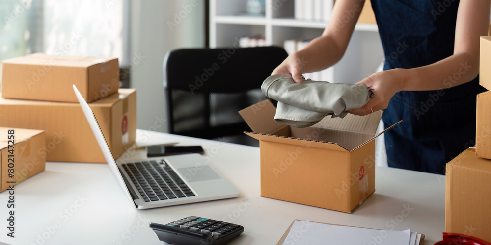 Asian business owner working at home with packing box of her online store prepare to deliver product to customers, sme business ideas online concept Asian business owner working at home with packing box of her online store prepare to deliver product to customers, sme business ideas online concept