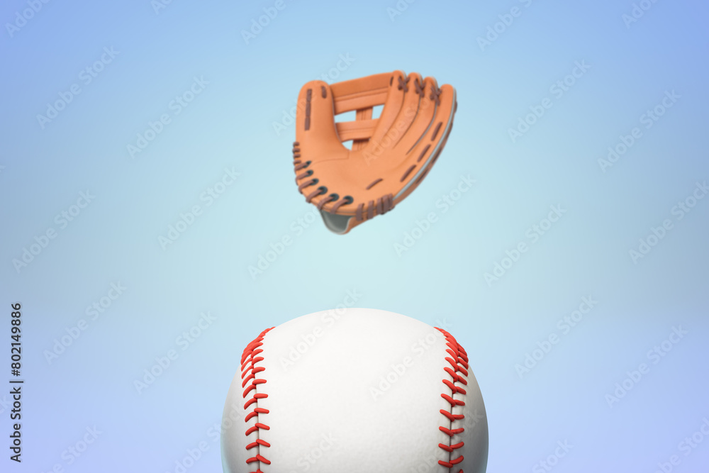 Naklejka premium Floating baseball glove above ball on blue