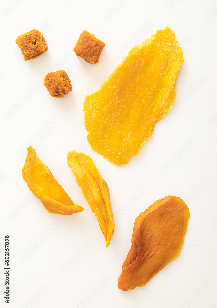 Various dried sweet mango slices and balls on white background. Various dried sweet mango slices and balls on white background.