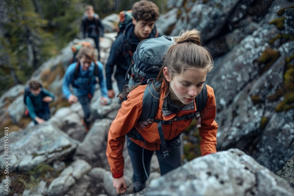 Teenagers showcasing determination and adventurous spirit hiking rocky trail