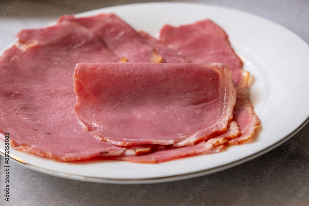 veal bacon on a white plate in macro shot veal bacon on a white plate in macro shot