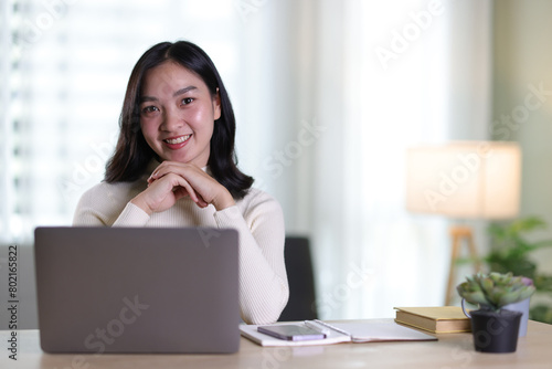 Young beautiful Asian woman working at home. © Kainnika