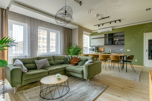 Modern Urban Apartment Living Room with Stylish Green Sofa and Open Kitchen
